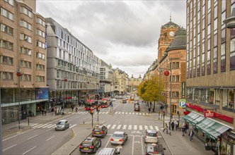 View of a busy city street with cars and historic buildings on a cloudy day Stockholm