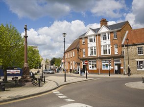 Buildings and war memorial in the Market Place in Thetford, Norfolk, England, United Kingdom,