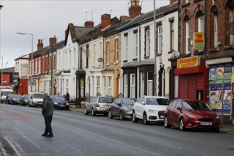 A man walks across a street near Liverpool FC's football stadium, 02/03/2019