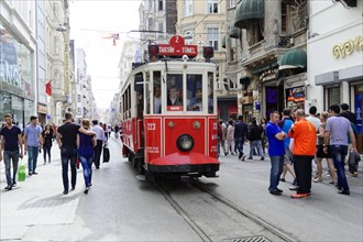 Historic tram Nostaljik Tramvay travelling through Istiklal Caddesi shopping street, Beyoglu,