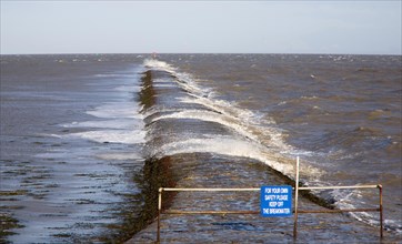 High seas forcing waves over the harbour mouth breakwater at Harwich, Essex, England, United