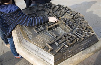 Child pointing at location on three dimensional model of the city centre, Cambridge, England,