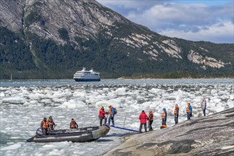 Passengers of the cruise ship Stella Australis board an inflatable boat between ice floes at Pia