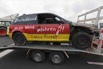 Accident car painted in Germany colours, with the inscription Deutschland vor den Wand gefahren,
