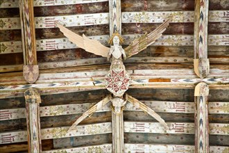 Carved wooden angel in ancient roof beams in Holy Trinity church, Blythburgh, Suffolk England
