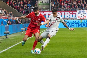 Football match, Piero HINCAPIE Bayer Leverkusen right in a duel with Eren DINKCI 1.FC Heidenheim,