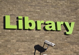 Green lettering sign for Library with CCTV camera