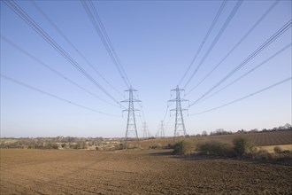 Electricity pylons and transmission lines cross countryside, Claydon, Suffolk, England, United