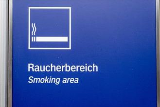 Blue and white sign on a wall indicating the smoking area, Germany, Europe