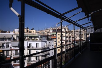 View from the roof terrace of a residential building to residential buildings and roof antennas,
