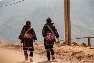 Women from the Hmong tribe wearing their traditional clothes while walking back to Lao Cai Village