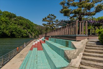 Colorful riverside walkway with steps and a railing on a sunny day, in South Korea