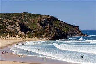 Surfing beach Playa Bodeiro in the Algarve, wide, red rock, rocky coast, nobody, clear, blue sky,