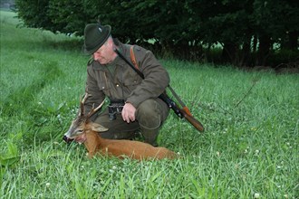Hunter with an old european roe deer (Capreolus capreolus) Lower Austria, Austria, Europe