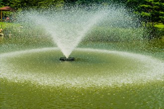 Close-up of water droplets in motion at a pond fountain, dynamic and lively, in South Korea