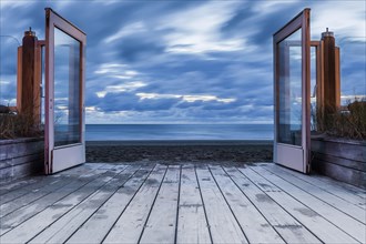 View through open glass door to the North Sea, clouds, movement, long exposure, move, cloudy sky,