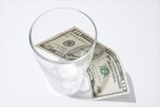 Ten Dollar Bill Inside and Outside of a Drink Glass