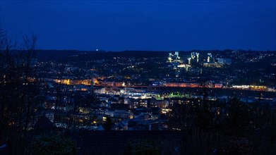 View of an illuminated cityscape during the blue hour with a clear evening sky, Bergische