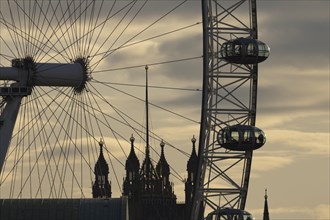 London Eye or Millennium Wheel tourist observation wheel close up of pods and spokes at sunset with