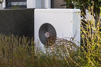 Heat pump in the front garden of a terraced house in Duesseldorf, North Rhine-Westphalia, Germany,