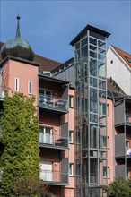 Pink facade with external lift, Kempten, Allgaeu, Bavaria, Germany, Europe