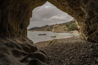 View from a cave to the coast near Malolo, Milos, Cyclades, Greece, Europe