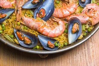 Freshly cooked seafood paella with vibrant colors served in a rustic pan, typical Spanish cuisine,