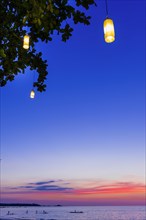 Evening mood at sunset with typical Thai lamps in the tree, sea, ocean, mood, evening mood, sky,