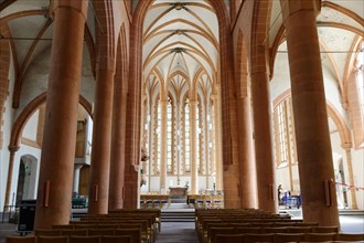 Interior of a large church (Heiligkreuzkirche), with high arches and long pews, Heidelberg,