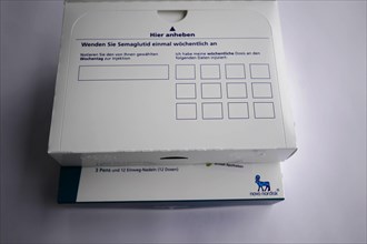 Opened medication packaging with instructions and dosage table, empty space for labelling, for