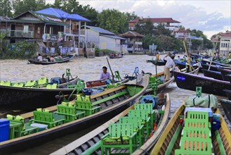 Lively river scene with people steering boats and transporting goods, Pindaya, Inle Lake, Myanmar,