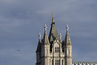 Airbus A380 aircraft of Emirates airlines in flight with Tower Bridge in the foreground, London,