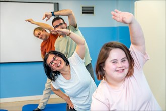Group of diverse disabled people exercising happily in the gym