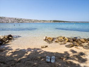 Bathing bay, beach shoes in the sand, island of Rab, Kvarner Gulf Bay, Croatia, Europe