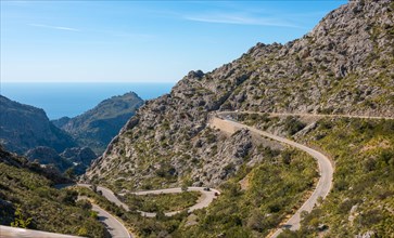 Mountain landscape with winding mountain road from Sa Calobra to Torrent de Pareis, cars and a