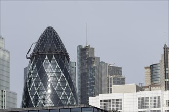 The Gherkin skyscraper building and nearby high rise office buildings, City of London, England,