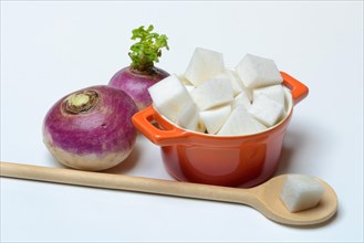 Purple turnip and split turnip in pot, Brassica rapa