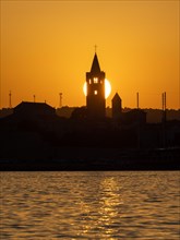 Golden evening light at sunset, silhouette of the church towers of Rab, town of Rab, island of Rab,