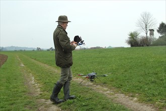 Hunter launches drone during a hare (Lepus europaeus) census, Lower Austria, Austria, Europe