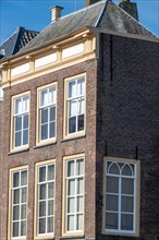 Side view of an old brick building with gabled roof and several windows, Middelburg, Zeeland,