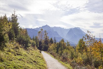 Wetterstein mountains with Alpspitze, Zugspitze massif and houses with hiking trail Philosophenweg,