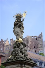 Sculpture on a golden pedestal, Marienbrunnen, in front of the ruins of a castle, Heidelberg,