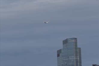 Aircraft of British airways in flight over a city skyscraper building, London, England, United