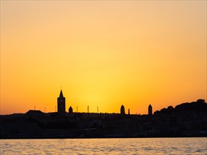 Sunset after sunset, silhouette of the church towers of Rab, town of Rab, island of Rab, Kvarner