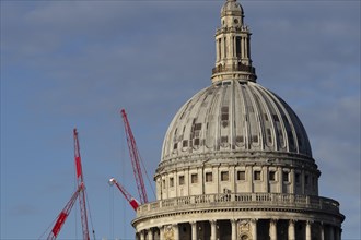 Dome of St Paul's Cathedral with industrial cranes in the background, City of London, England,