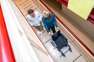Top view of a man with down syndrome and caregiver using wheelchair