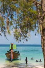 Muslim woman bathing on the beach, longtail boat, wooden boat, boat, decorated, tradition,