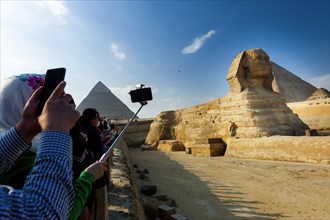Tourists photograph the Sphinx of Giza, desert, wonder of the world, structure, sculpture,