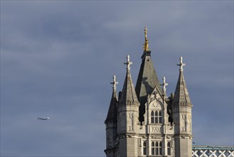 Airbus A380 aircraft of Emirates airlines in flight with Tower Bridge in the foreground, London,