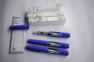 Ozempic injection pens and needle packages arranged on a table, for diabetes 2 patients, Stuttgart,